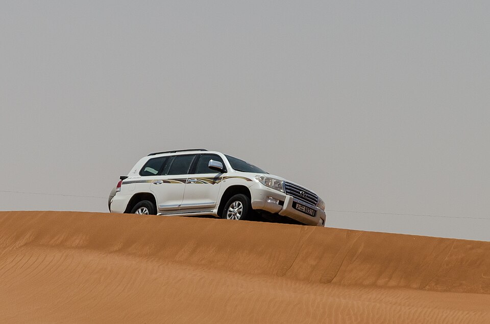 A Toyota Land Cruiser on desert sand
