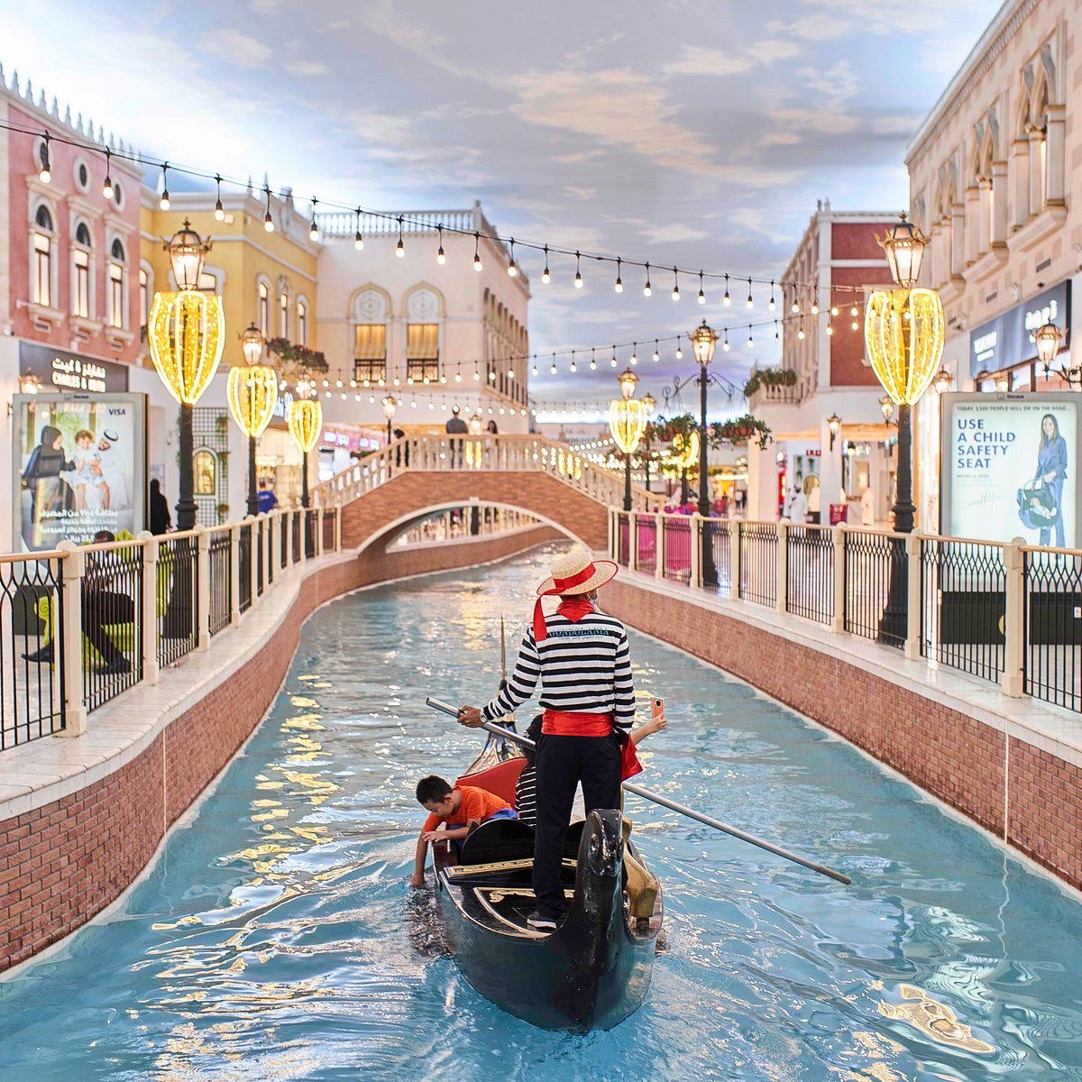 A gondolier steering along the indoor canal at Villaggio Mall
