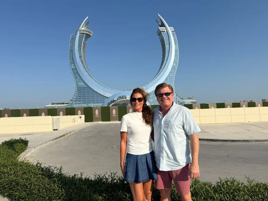 A couple in front of the twin crescents of Katara Towers