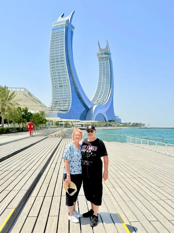Two guests on the Lusail boardwalk beneath the Katara Towers