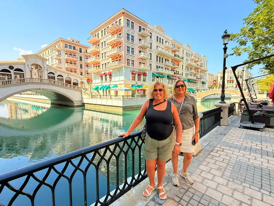 Guests on the canal bridge at Qanat Quartier, The Pearl