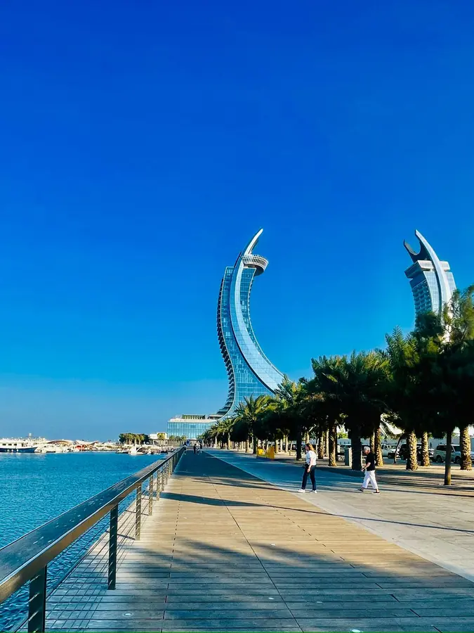 Palms along the Lusail boardwalk with the Katara Towers ahead