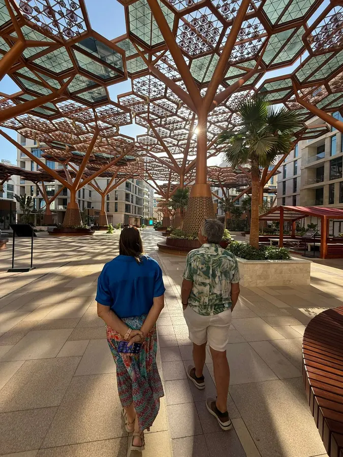 Guests walking beneath a latticed timber canopy